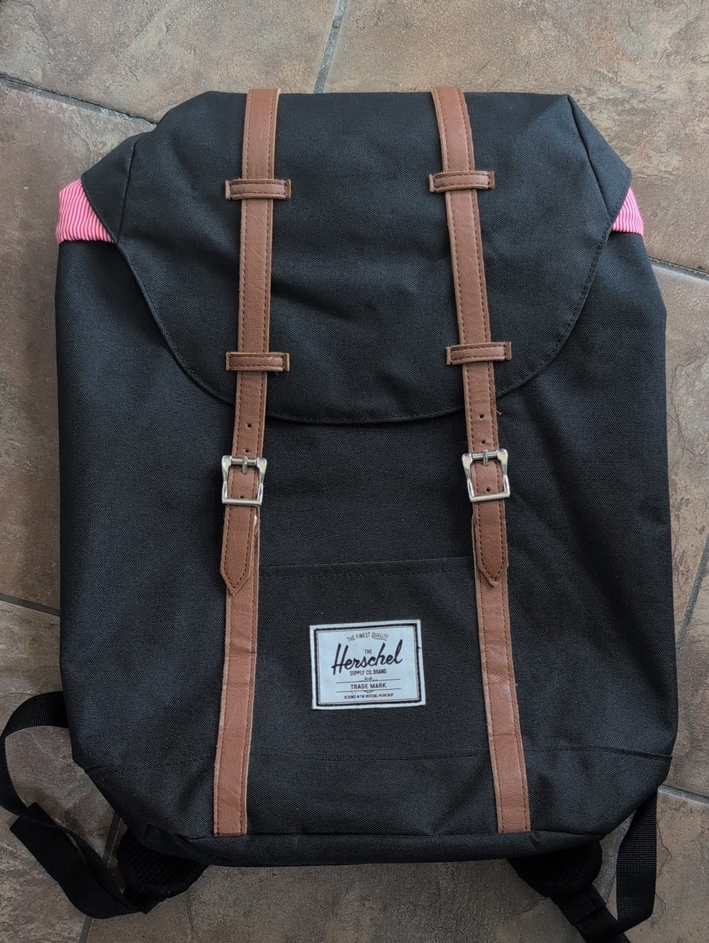 Herschel Supply Company black backpack with brown straps and pink accents